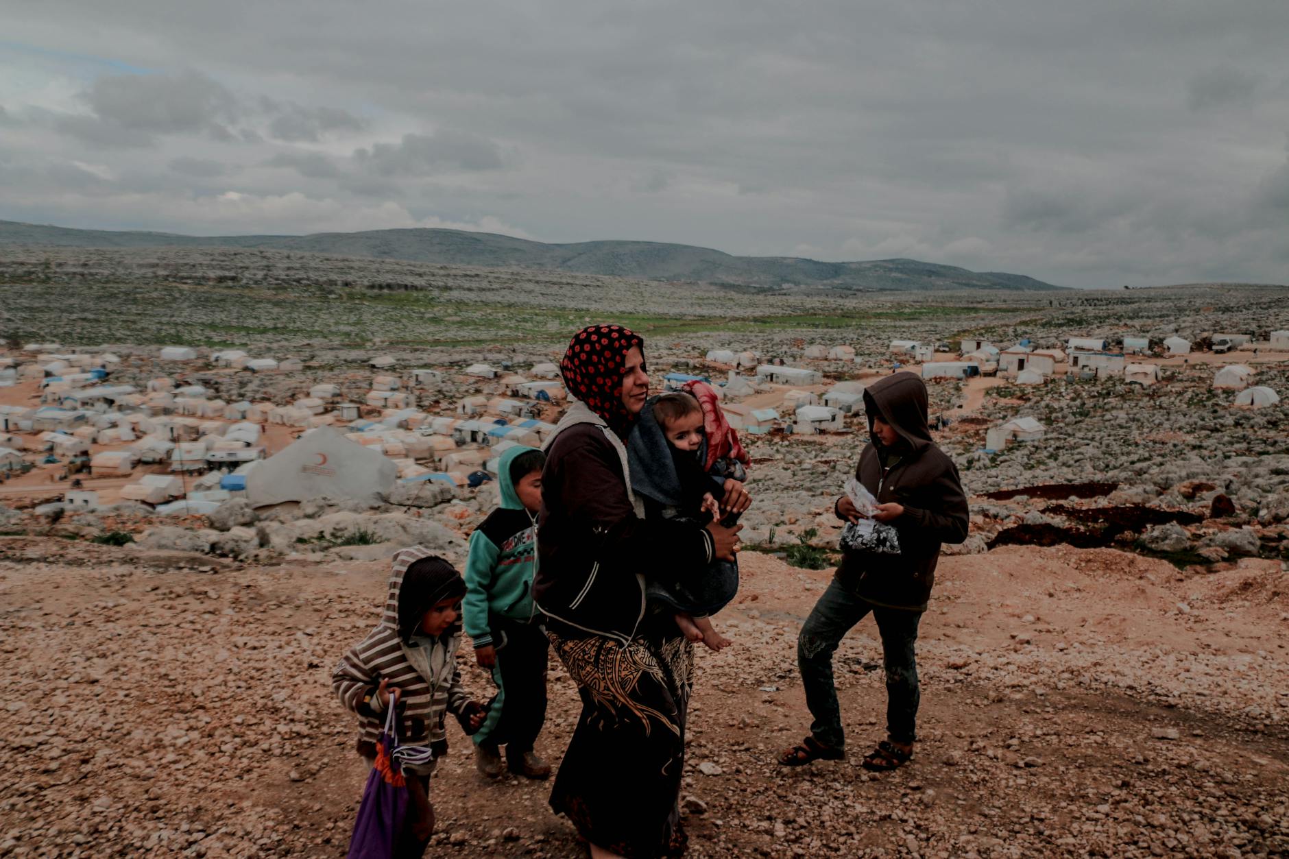 muslim ethnic mother with baby in arms and children around